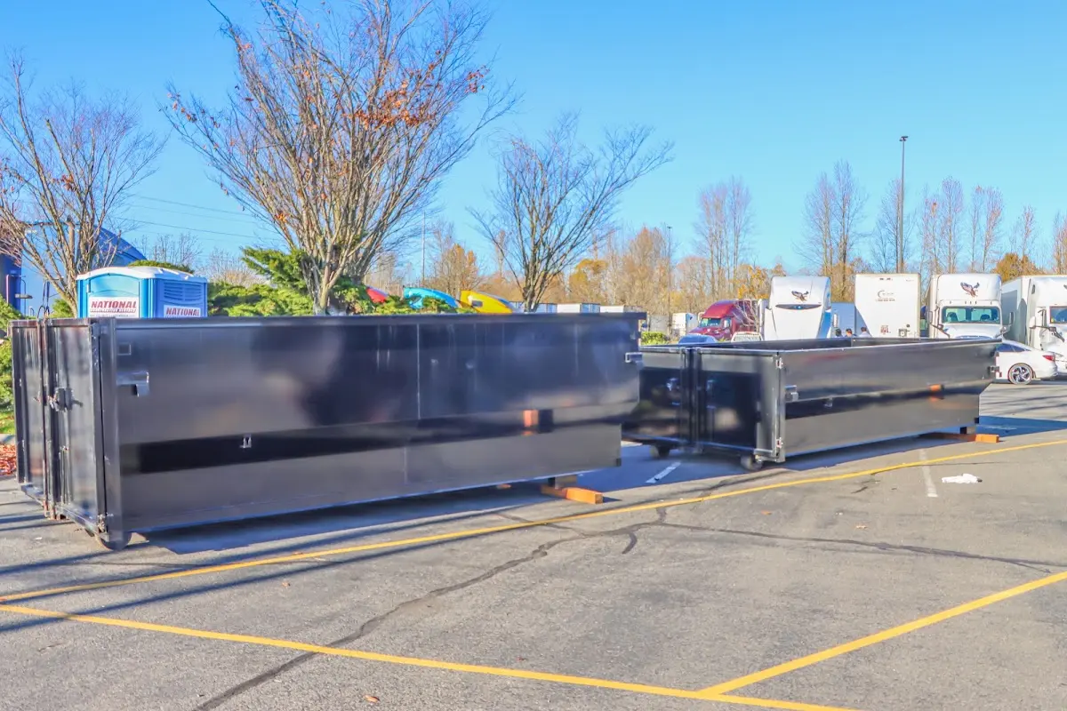 Professional dumpster rental service with roll-off container on residential driveway in Whittier